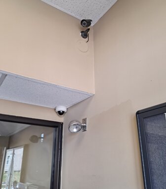 Dome and bullet camera monitoring an entry vestibule