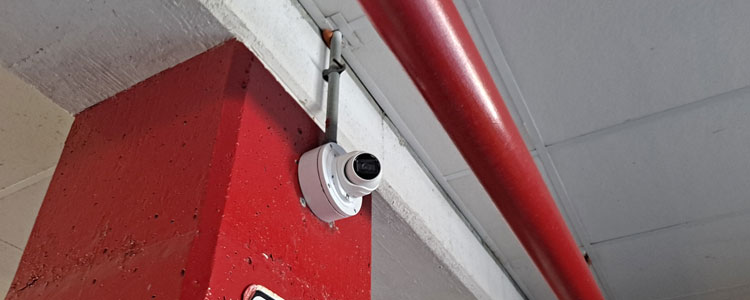 Turret cameras monitor this ground-level parking lot
