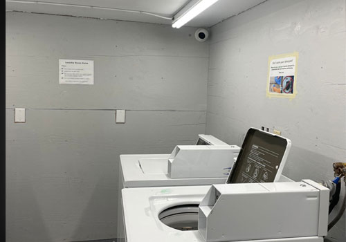 laundry room with turret camera and electronic access control door lock