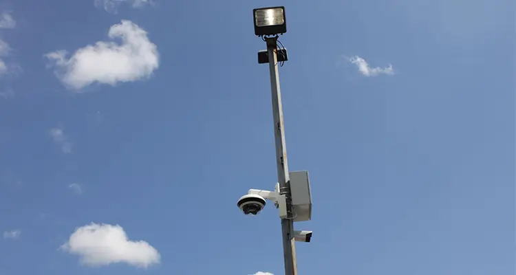Hardwired outdoor commercial cameras on pole for parking lot security