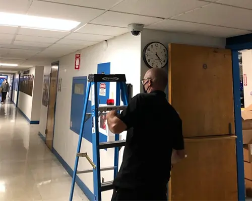 Security camera installation in a school hallway